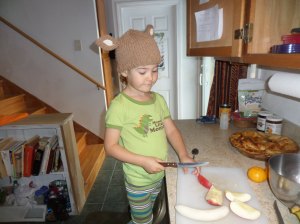 Using the child-safe brown-handled knife to cut apples