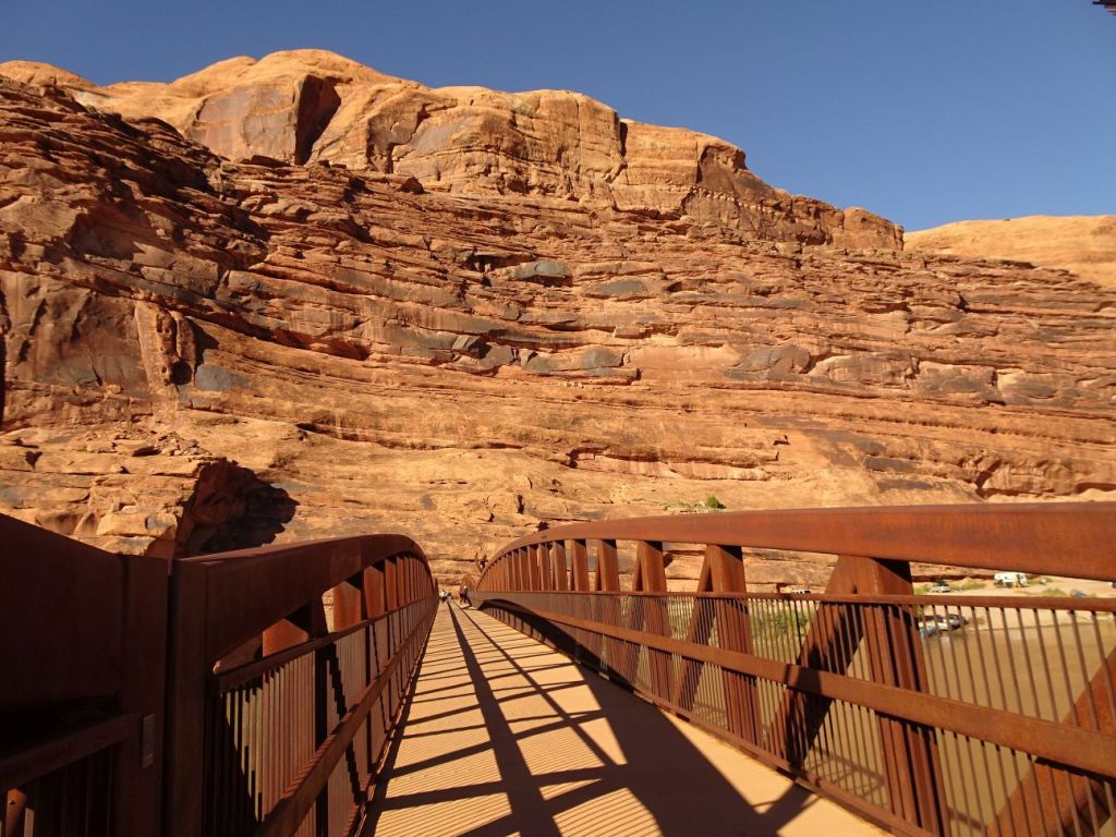 Wooden bridge over the Colorado river, with mountains in the background